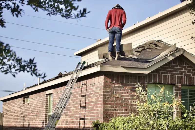 Professional roofer working on a residential roof in Oak Hills